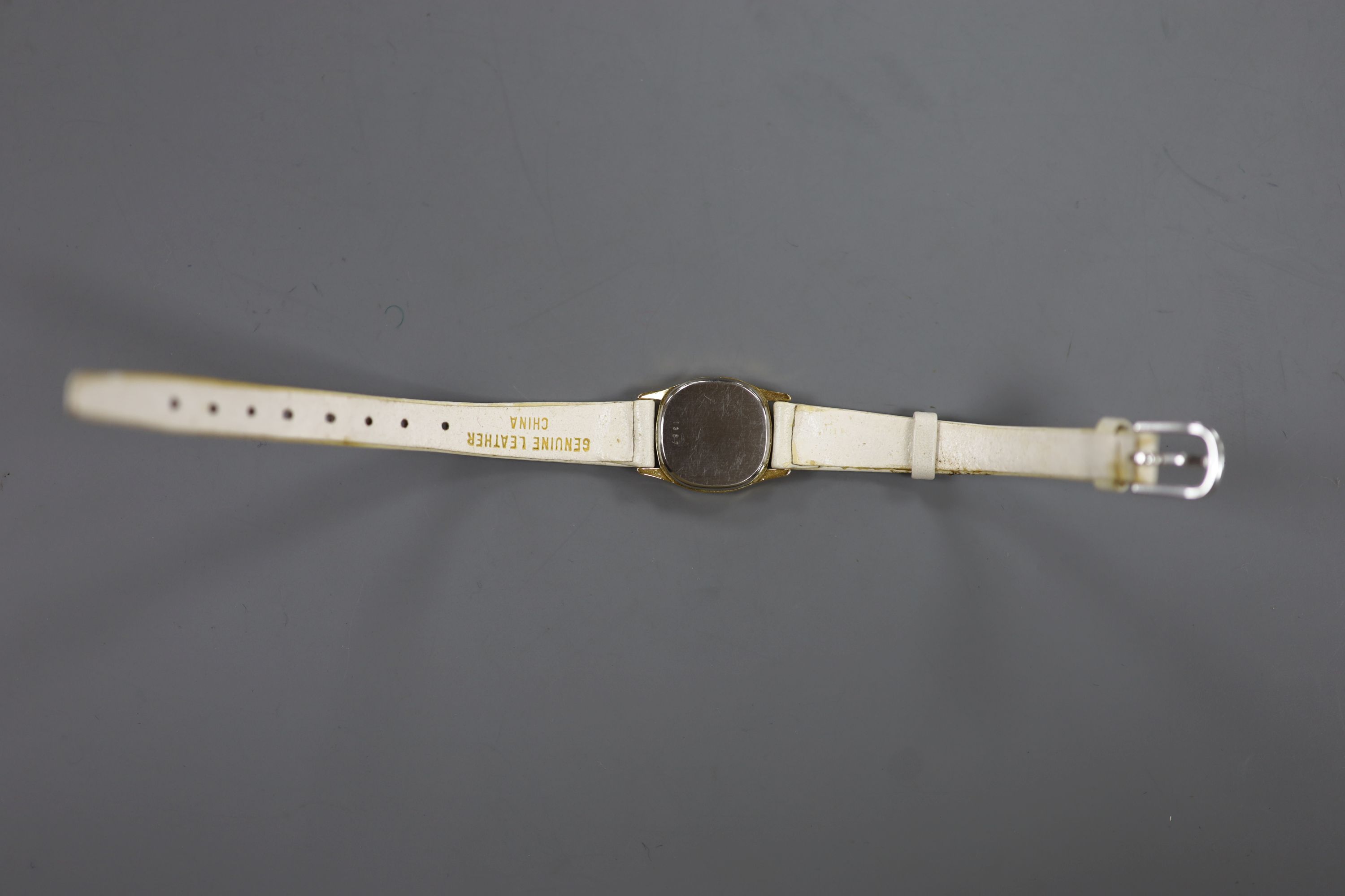 A lady's steel and gold plated Omega De Ville quartz wrist watch, on an associated leather strap.